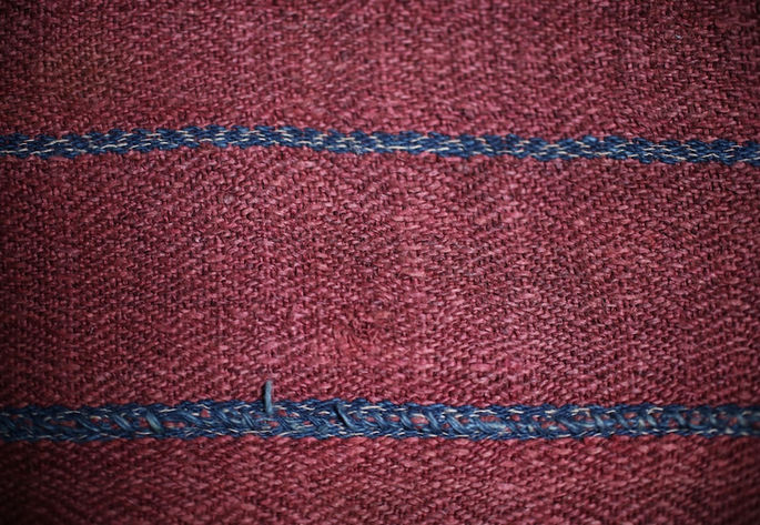 A close-up shot of one section of the skirt, showing a textured background with diamond patterns embedded within the stripes