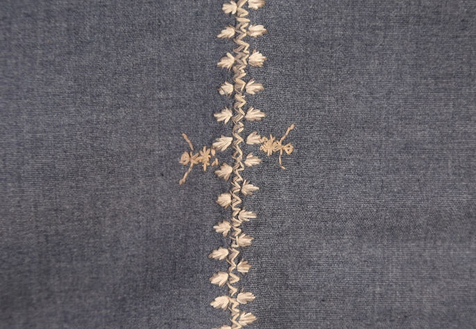 A closer look on the embroidered joineries featuring zigzag, rice stalks or fingernails, and human figures