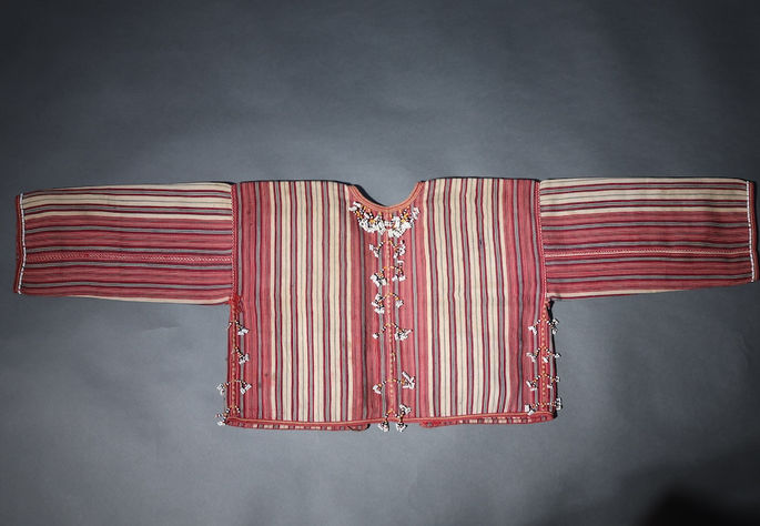 Tassel beads are embellished along the neckline at the back of the blouse