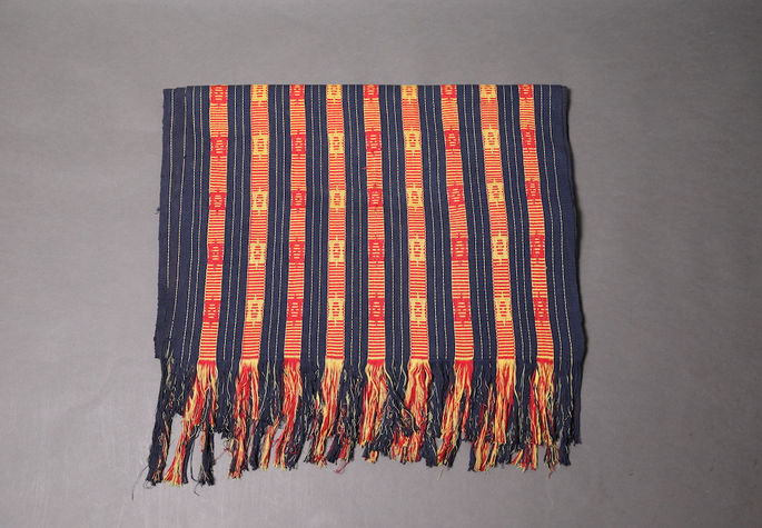 A hero shot of an indigo striped yardage with chopped and frayed ends