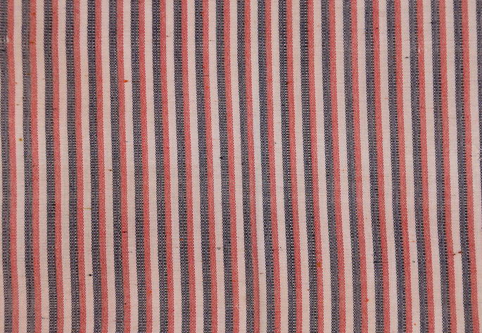 A close-up shot highlighting the indigo, orange, and white striped design of the textile