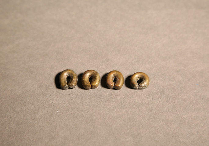 A hero shot of a set of brass barter rings, uniform in size and form