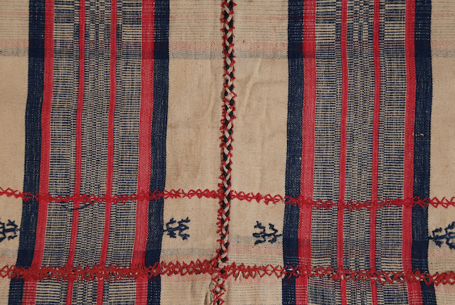 A closer look at the woven and embroidered designs in red and black