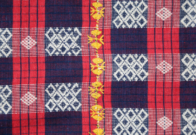 A closer shot focusing on the yellow embroidered joinery.