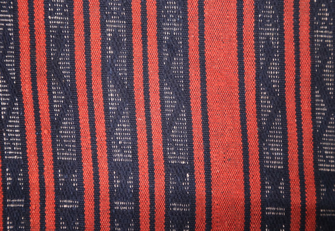 Snake-like motifs are also woven into the indigo stripes