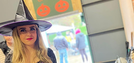 Woman dressed as a witch at a pumpkin patch event