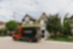 Wide angle of Firefly Solar service van in a residential street installing solar on a home