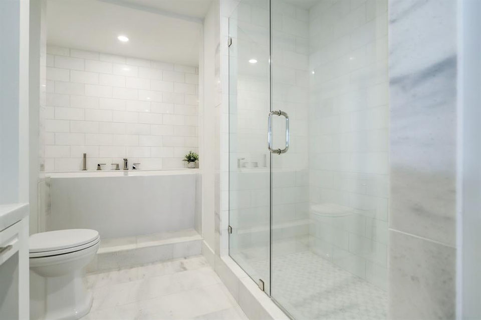 White master bathtub and shower at the Willowick high rise in River Oaks, Texas
