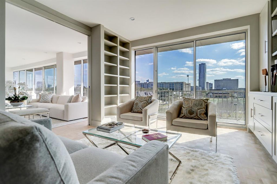 Sunlit home library with city view at the Willowick high rise in River Oaks, Texas