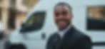 Smiling Alpha Security guard in a formal suit offering event and personal security services in the Surrey
