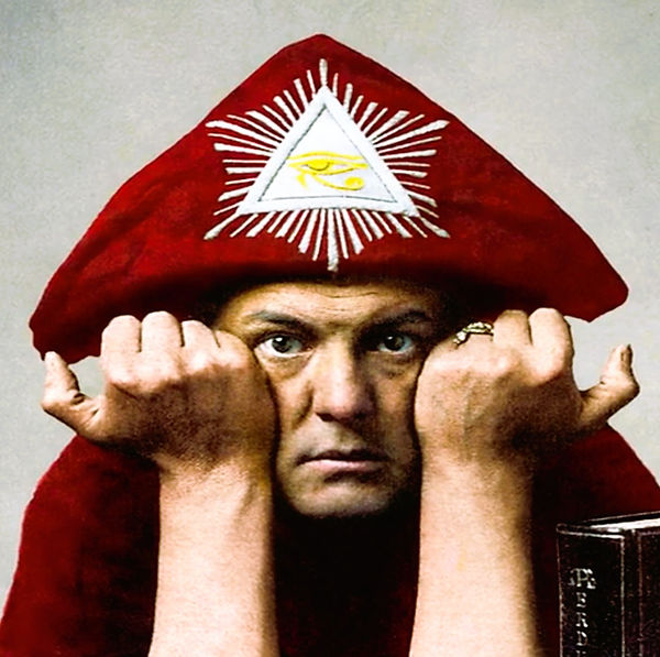 Album cover for Aleister Crowley – The Master Therion Speaks! [Restored] (2025). A red-robed figure wearing a matching hat adorned with a white triangle and yellow Eye of Horus symbol. The figure rests their face on clenched fists. A book with partial text “APE” and “ERD” appears in the lower corner, evoking ceremonial and esoteric themes.