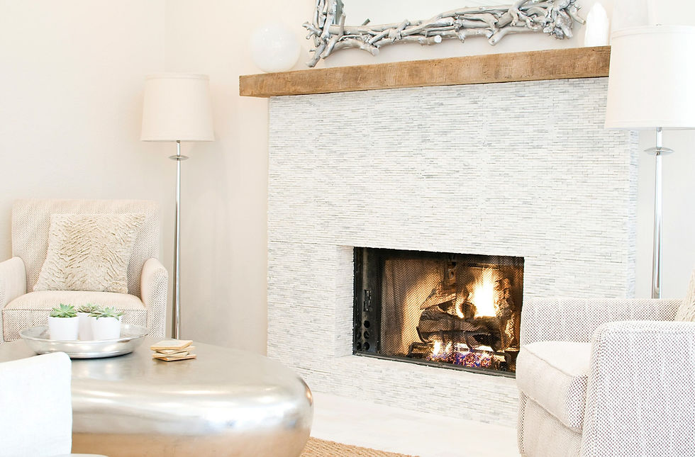 Modern white stone fireplace with a wooden mantel.