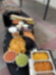 Buffet table with chips, salsa, guacamole, rice, and beans