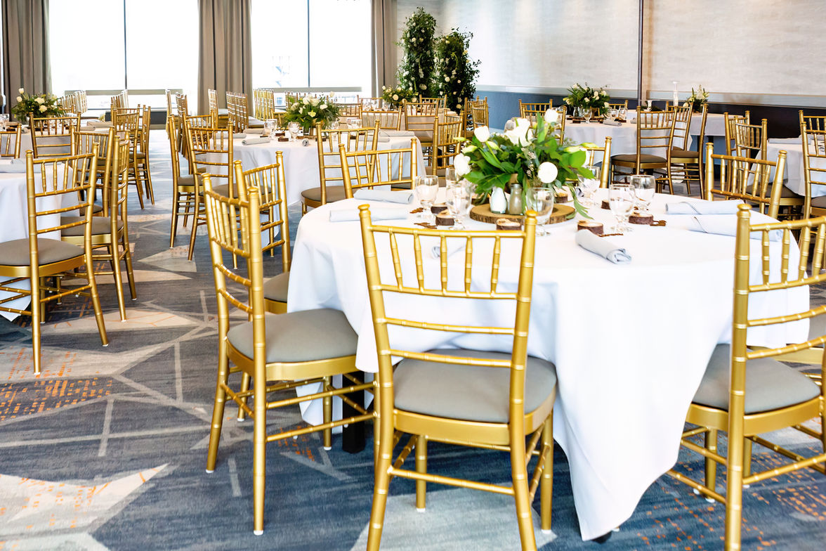 Reception area with white tables, gold chairs