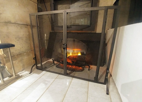 Freestanding mesh fireplace screen with doors in vintage iron finish at The Fireplace Shop Ltd.