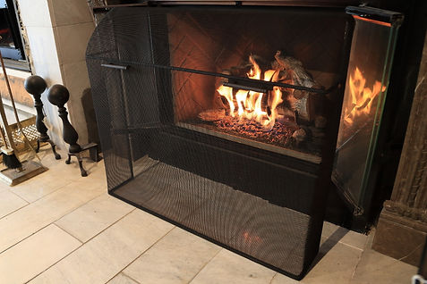 Custom curved mesh firescreen with matte black handles and finish