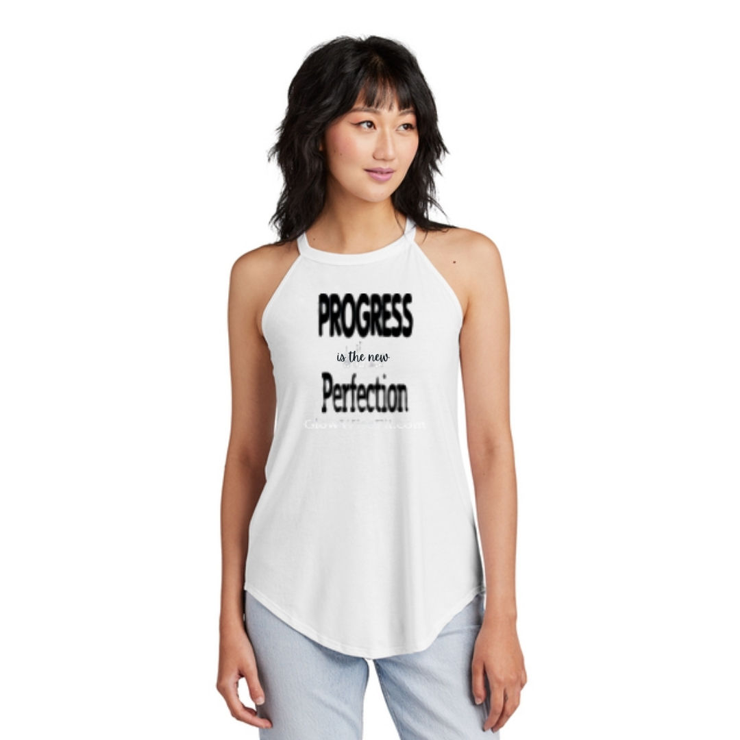 Woman in a white high-neck flowy tank top that reads “Progress is the new Perfection”
