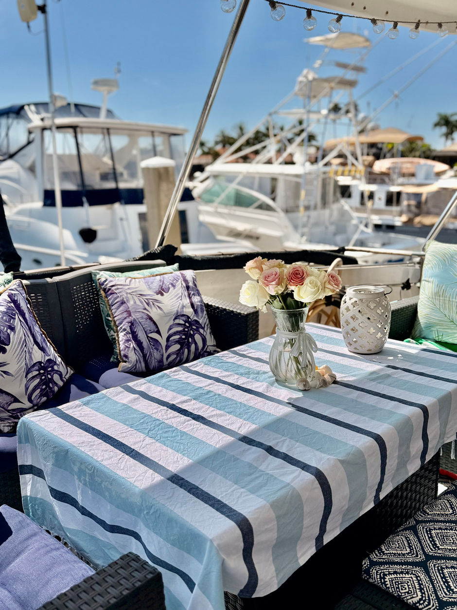 A casual table set on the aft deck of a motoryacht in Florida on a sunny day.
