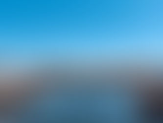 A view of a marina with boats and blue sky and water