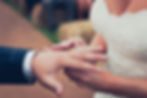 Close-up view of wedding rings on a rustic wooden table
