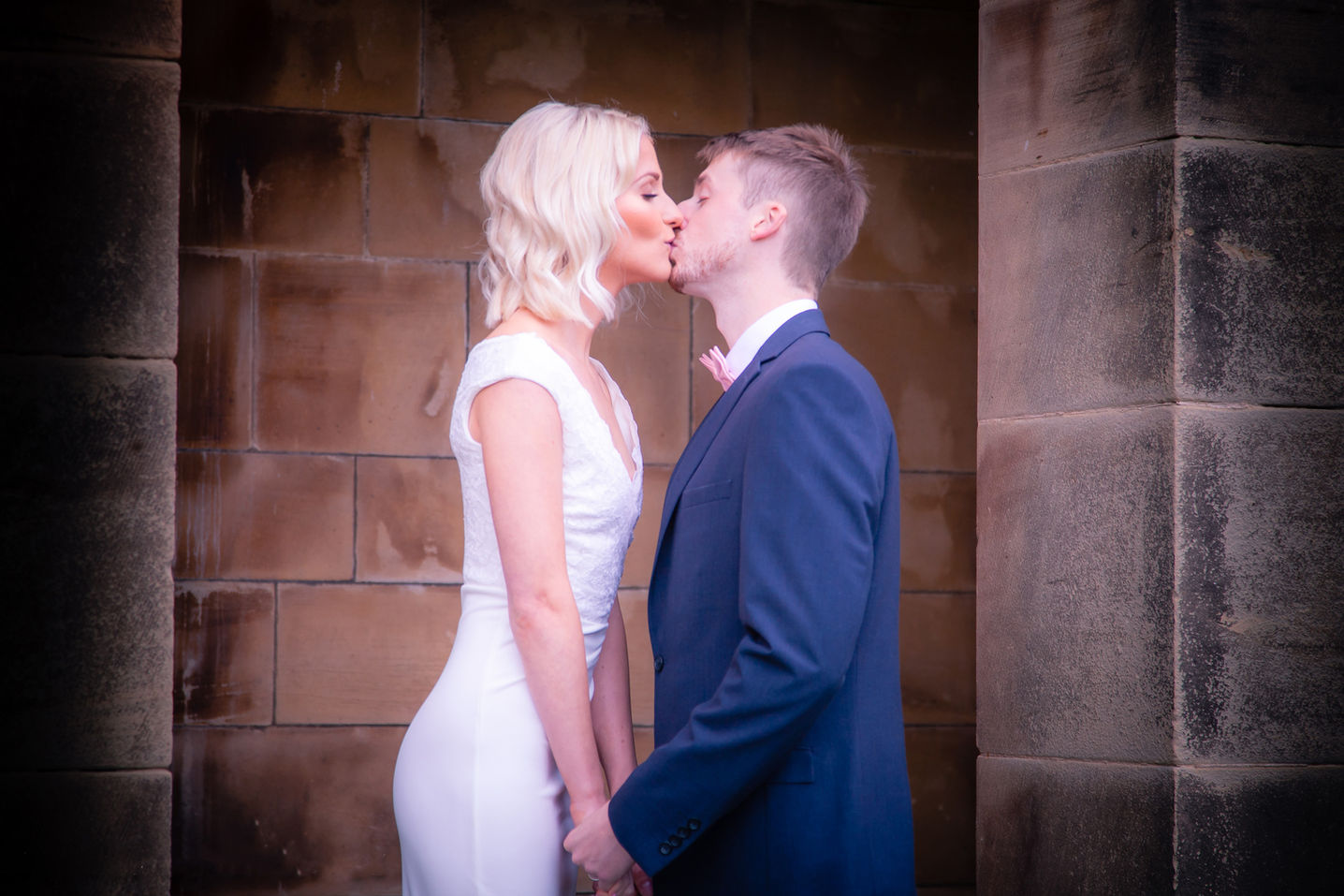 Wedding photographer captures wedding couple kissing at Crathorne Hall