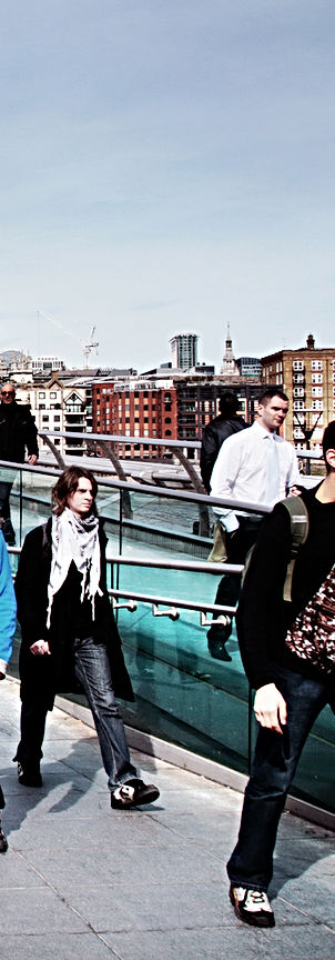 People walking across Millennium Bridge, St. Paul's Cathedral in background