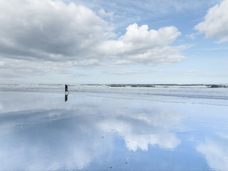 Arts photographer captures landcape photograph of wet sand reflects the sky