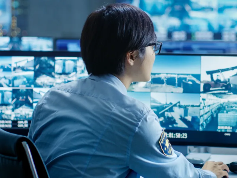in-the-security-control-room-officer-monitors-multiple-screens-for-picture-id890157172.web
