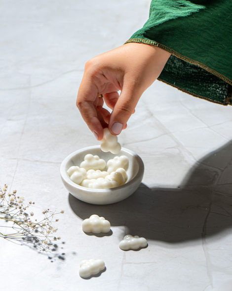 Premium skincare cream product photography Abu Dhabi hand model styling marble surface beauty brand photographer UAE Thinkid Media