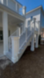 Modern white exterior staircase with cable railing