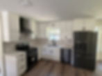 Modern kitchen with white shaker cabinets, new island and new tile flooring