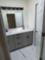 Modern bathroom with new tile floor, sink and cabinets