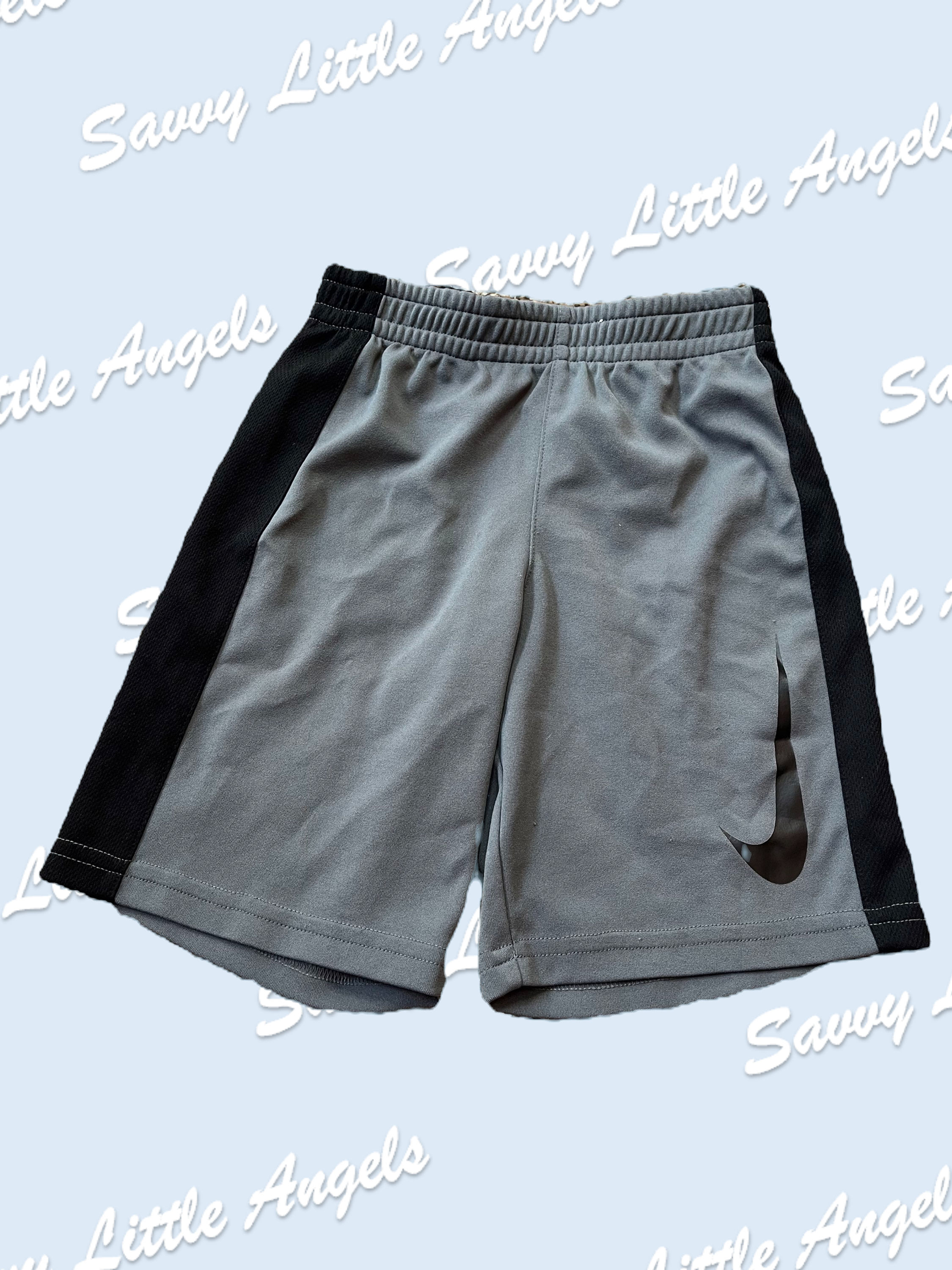 front of Grey and Black Nike Shorts