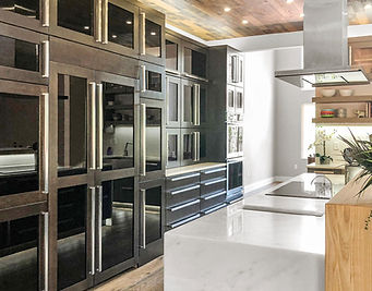 Custom kitchen design featuring contrasting cabinetry, integrated storage, and sophisticated architectural details.