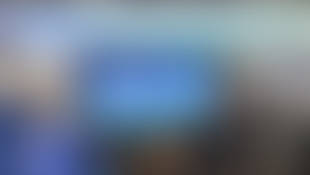 Crowd at China International Glass Exhibition under blue sign. People wearing masks and hats, indoors, energetic atmosphere.