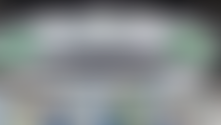 Large hall with booths at Saudi Agriculture International Trade Exhibition. White and green signage, lively atmosphere, industrial setting.