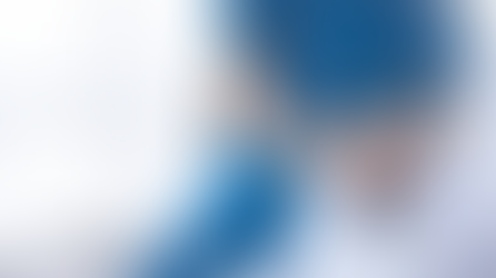 Insurance claim form on a wooden table stamped "REJECTED" in bold red. A pen lies nearby, indicating a denied claim.