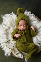 newborn photo of baby boy in green pj set
