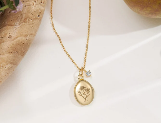 locket with birth flowers engraved on front
