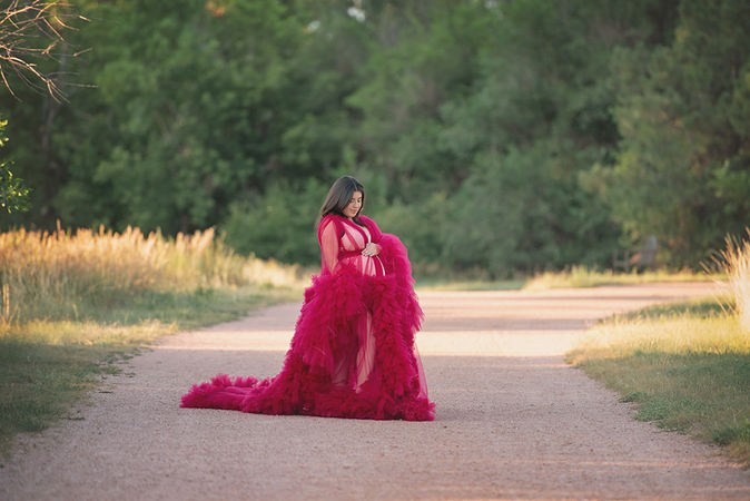 summer maternity photo in a flowing red gown