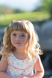 Outdoor photo of a little girl with blond hair
