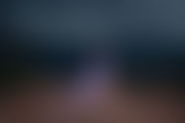 pregnant woman in light purple dress poses during rainstorm