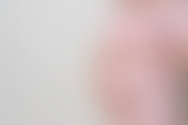 pregnant woman's belly in light pink open front gown
