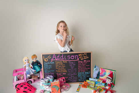 Photo of six year old girl with her favorite toys and a list of her favorite things