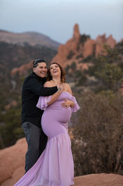 spring maternity photo at garden of the gods in lilac purple gown