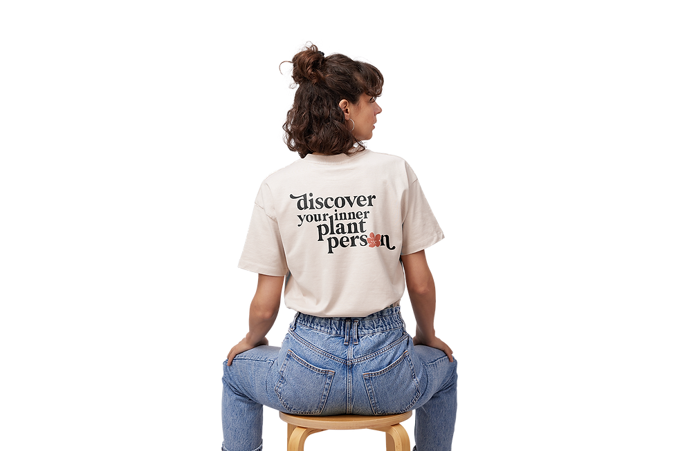custom branded merch design, woman wearing cream colored shirt with custom design on back saying "discover your inner plant person"
