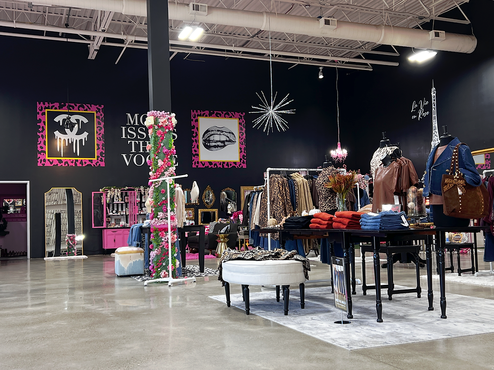 Boutique interior with clothing racks and wall art