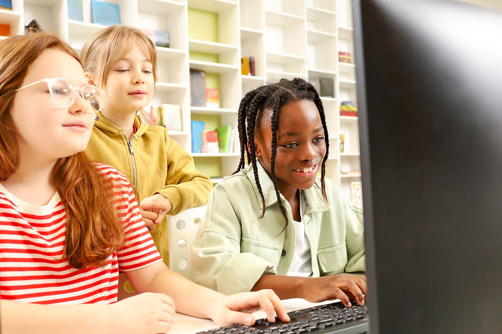 Three diverse children focused on a computer screen in a library.