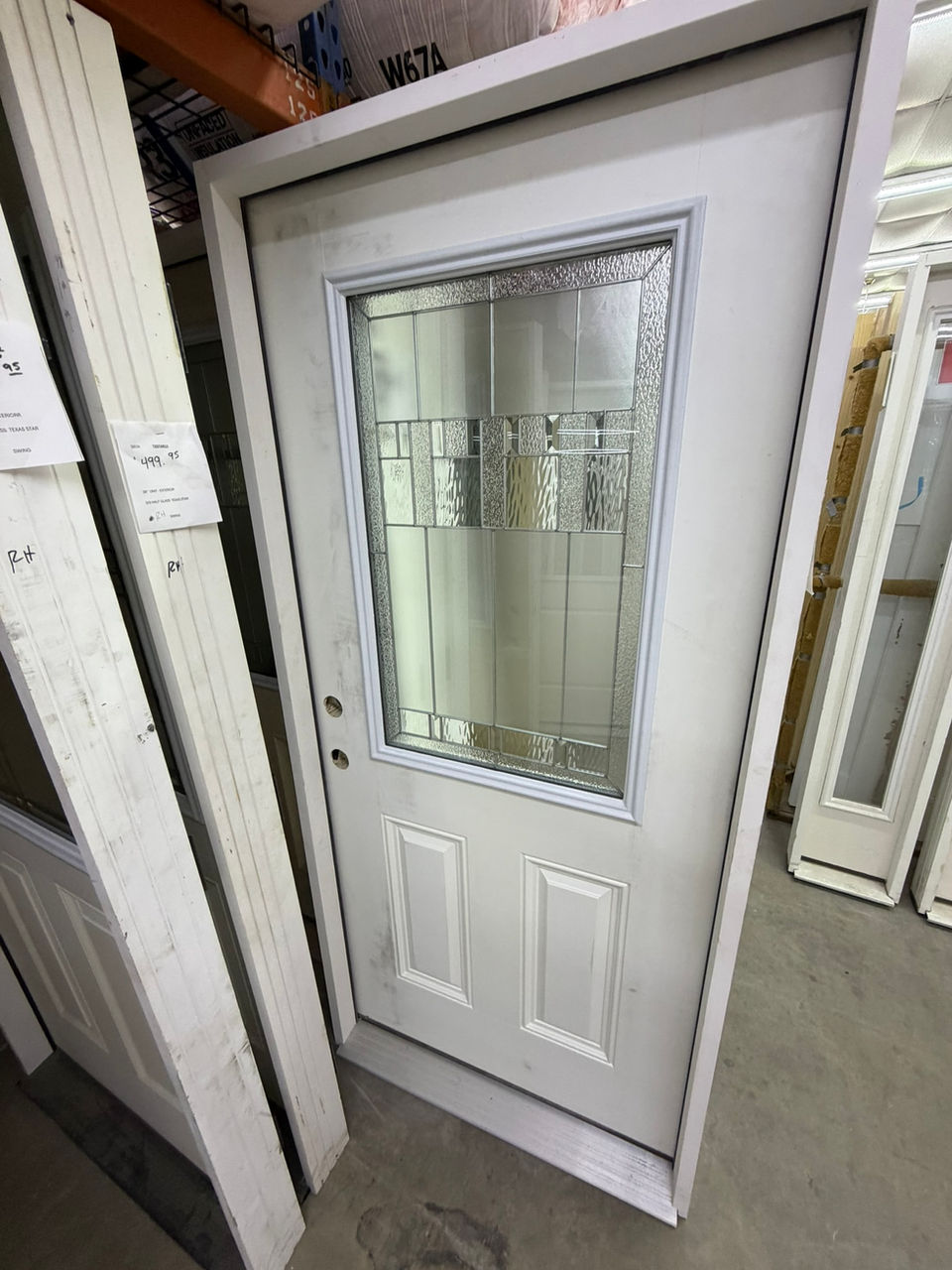 White exterior door with large glass insert and panels.