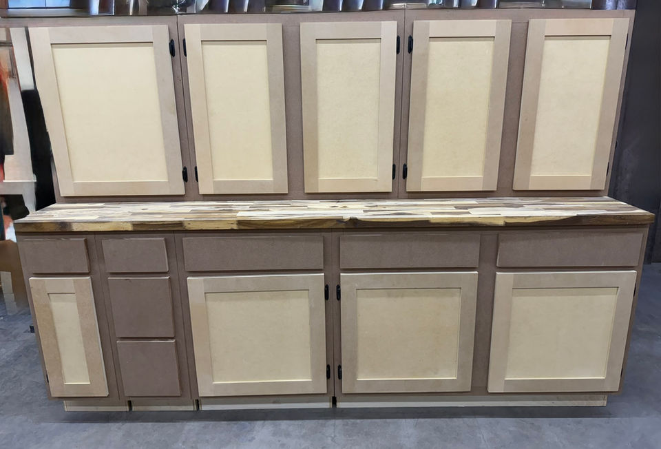 Custom light wood shaker cabinets with natural wood countertop.